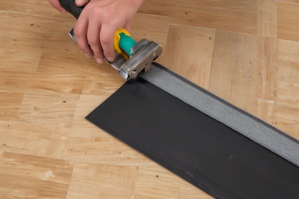 Professional vinyl flooring installation in progress showing expert craftsmanship
