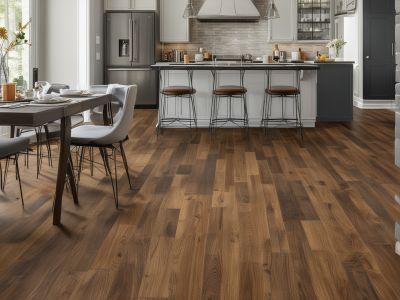 Modern kitchen with luxury vinyl plank flooring in warm wood tones, professional installation by Community Floors LLC